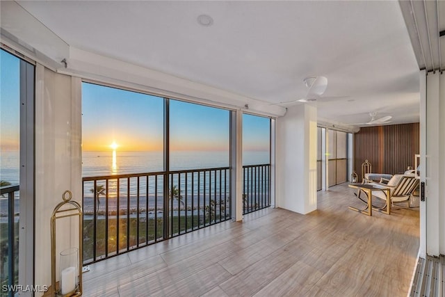 sunroom / solarium with plenty of natural light and a water view