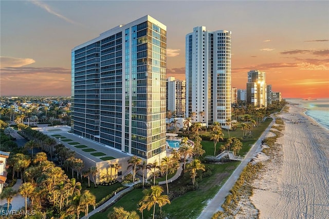 exterior space featuring a water view and a beach view