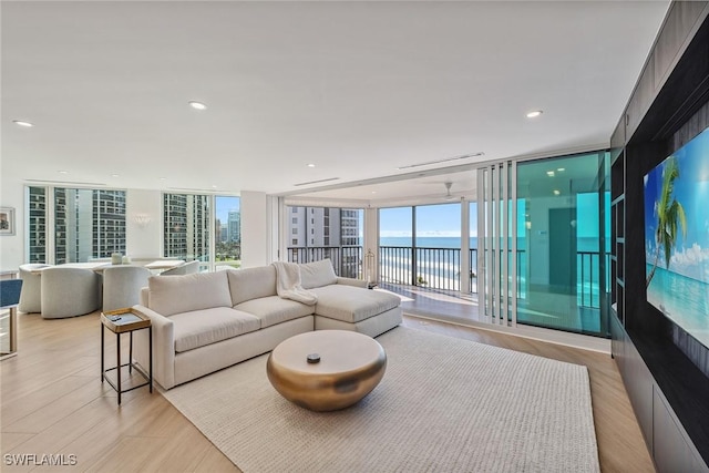 living room with light hardwood / wood-style floors and floor to ceiling windows