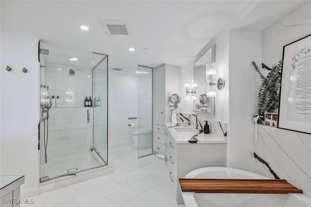 bathroom featuring a shower with door, toilet, and vanity