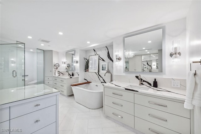 bathroom featuring vanity and separate shower and tub