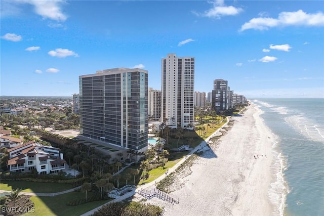 birds eye view of property featuring a water view and a beach view