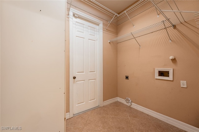 laundry room with hookup for a washing machine, gas dryer hookup, electric dryer hookup, and light tile patterned floors
