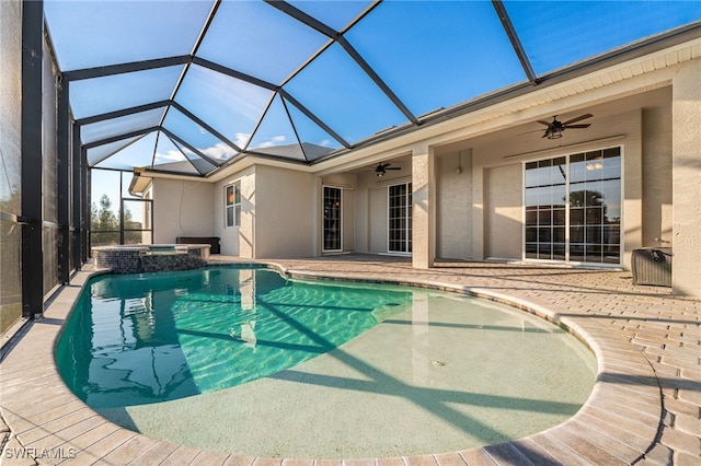 view of swimming pool featuring an in ground hot tub, a patio, ceiling fan, and glass enclosure