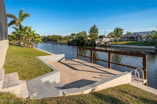 dock area with a water view and a yard