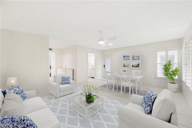 tiled living room featuring ceiling fan