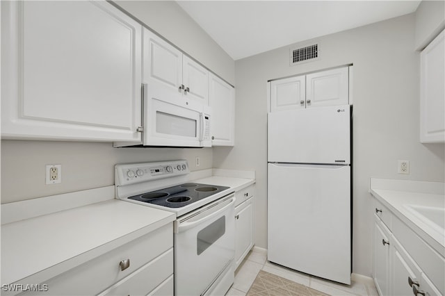 kitchen featuring white cabinets, white appliances, and light tile patterned floors