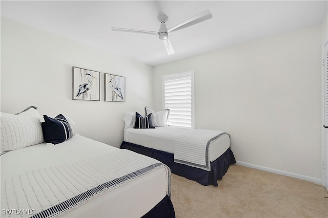 bedroom with ceiling fan and light carpet