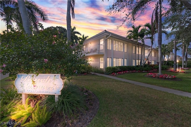 exterior space featuring a front lawn and stucco siding