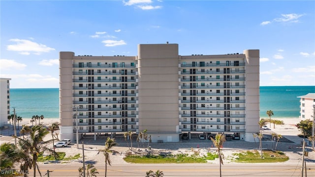 view of building exterior with a view of the beach and a water view