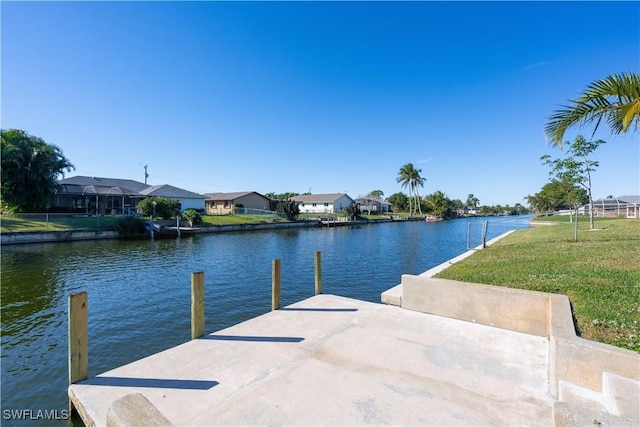 dock area with a water view and a yard