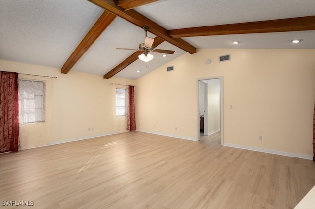 unfurnished room featuring light wood-type flooring, a textured ceiling, vaulted ceiling with beams, and ceiling fan