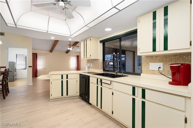 kitchen with sink, black dishwasher, light hardwood / wood-style flooring, backsplash, and cream cabinets