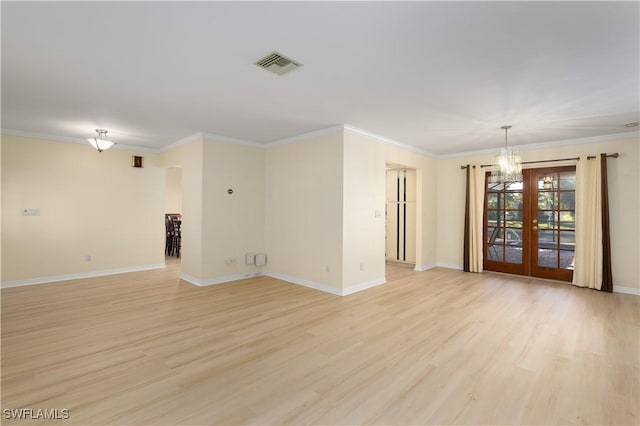 unfurnished room featuring light wood-type flooring, crown molding, and french doors