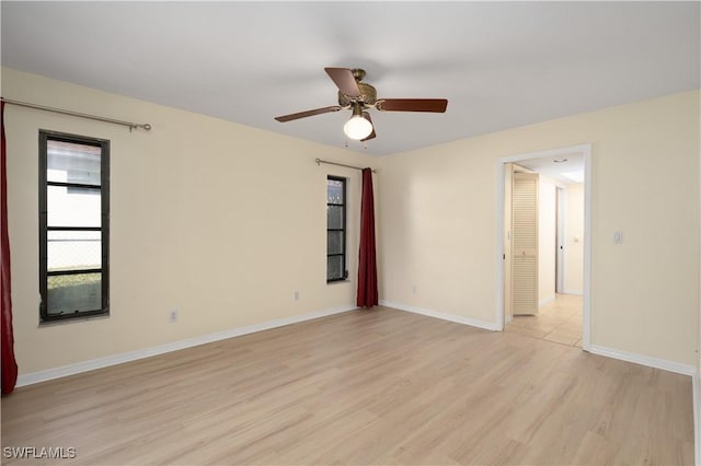 empty room with light wood-type flooring and ceiling fan