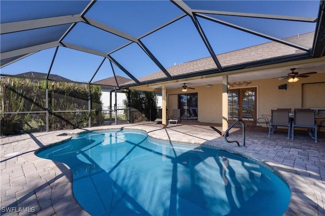 view of swimming pool featuring a lanai, ceiling fan, and a patio area