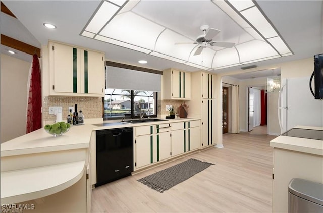 kitchen with decorative backsplash, cream cabinets, sink, and black appliances