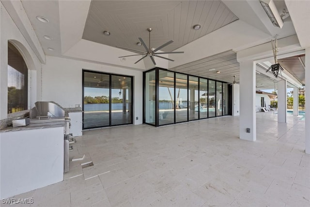 view of patio / terrace with ceiling fan and exterior kitchen