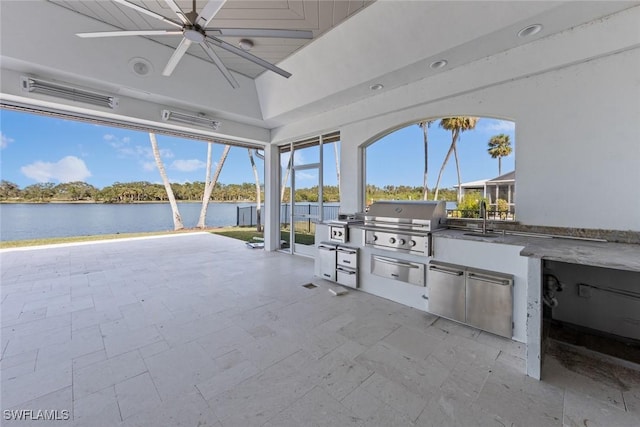 view of patio / terrace featuring a water view, sink, area for grilling, ceiling fan, and a grill