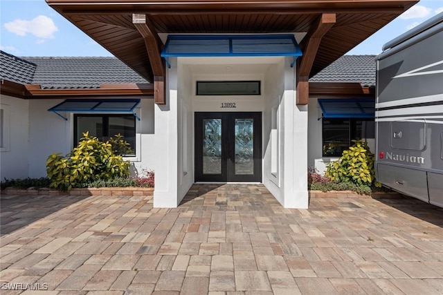 view of exterior entry featuring french doors