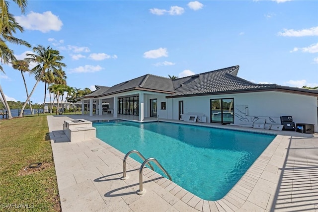 view of swimming pool with a yard and a patio