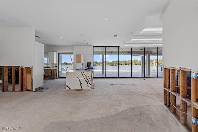 unfurnished living room with a water view