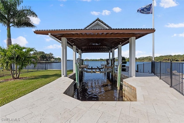 dock area featuring a lawn and a water view