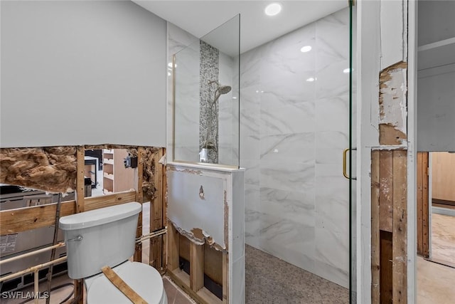 bathroom with an enclosed shower and toilet