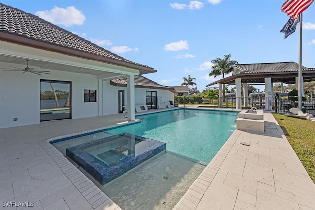 view of swimming pool with an in ground hot tub, a patio, and ceiling fan