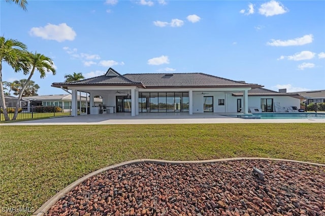 rear view of house with a yard, ceiling fan, and a patio area