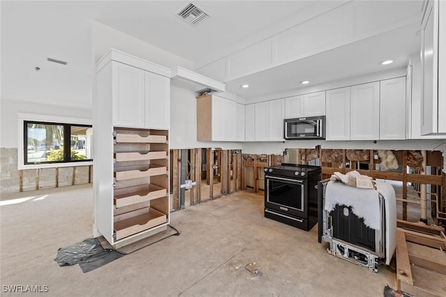 kitchen with black / electric stove and white cabinets