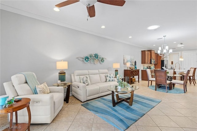 living room with ceiling fan with notable chandelier, light tile patterned flooring, and crown molding