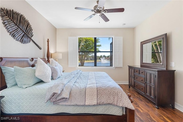 bedroom with ceiling fan and dark wood-type flooring