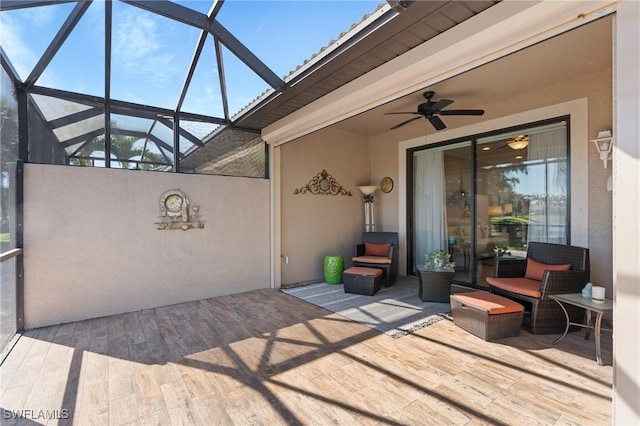 view of patio / terrace with ceiling fan and a lanai