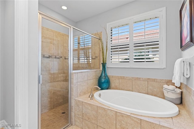 bathroom featuring independent shower and bath