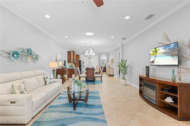 living room featuring light tile patterned flooring, ceiling fan with notable chandelier, and ornamental molding