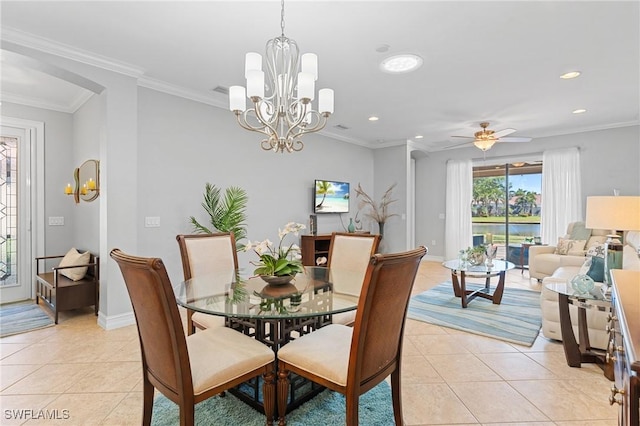 tiled dining area featuring ceiling fan with notable chandelier and ornamental molding