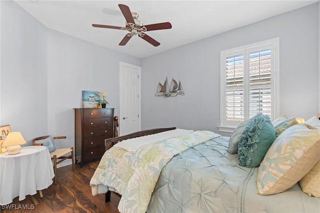 bedroom with dark hardwood / wood-style floors and ceiling fan