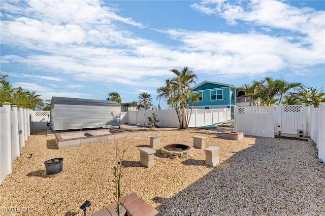 view of yard with an outdoor fire pit