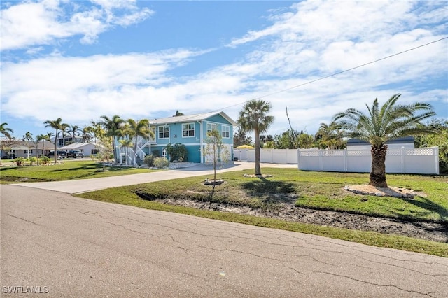 view of front of property with a front yard and a garage