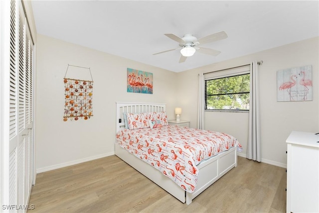 bedroom featuring a closet, light hardwood / wood-style flooring, and ceiling fan