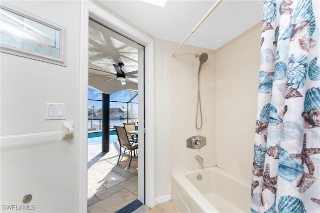 bathroom with tile patterned floors, ceiling fan, a water view, and shower / bath combo with shower curtain