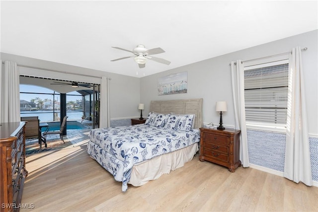 bedroom with ceiling fan, light hardwood / wood-style floors, and access to exterior