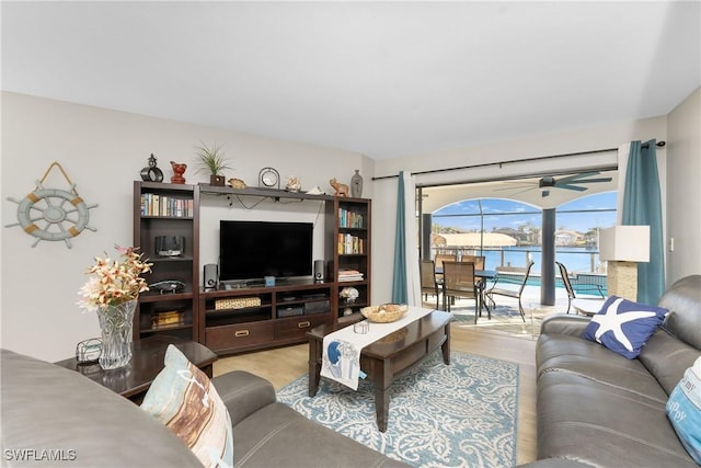 living room featuring light wood-type flooring and ceiling fan