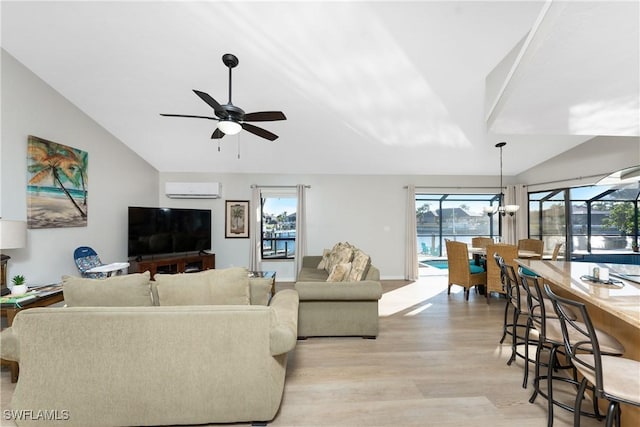 living room with a wall mounted air conditioner, light wood-type flooring, lofted ceiling, and a wealth of natural light