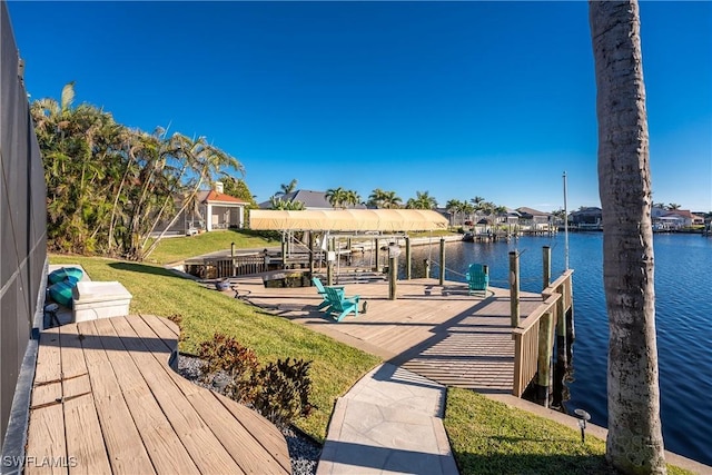 dock area with a yard and a water view