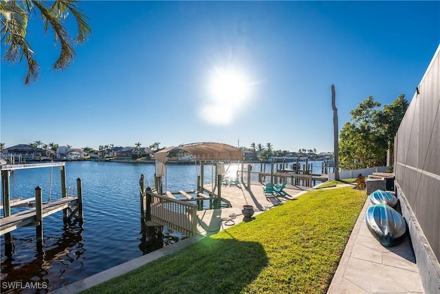 dock area featuring a lawn and a water view