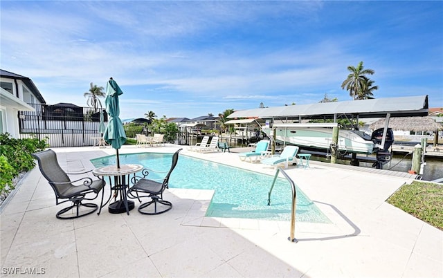 view of swimming pool featuring a boat dock