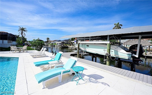 exterior space with a boat dock, a water view, and a patio