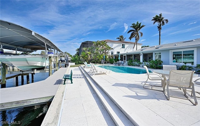 view of swimming pool featuring a dock and a water view